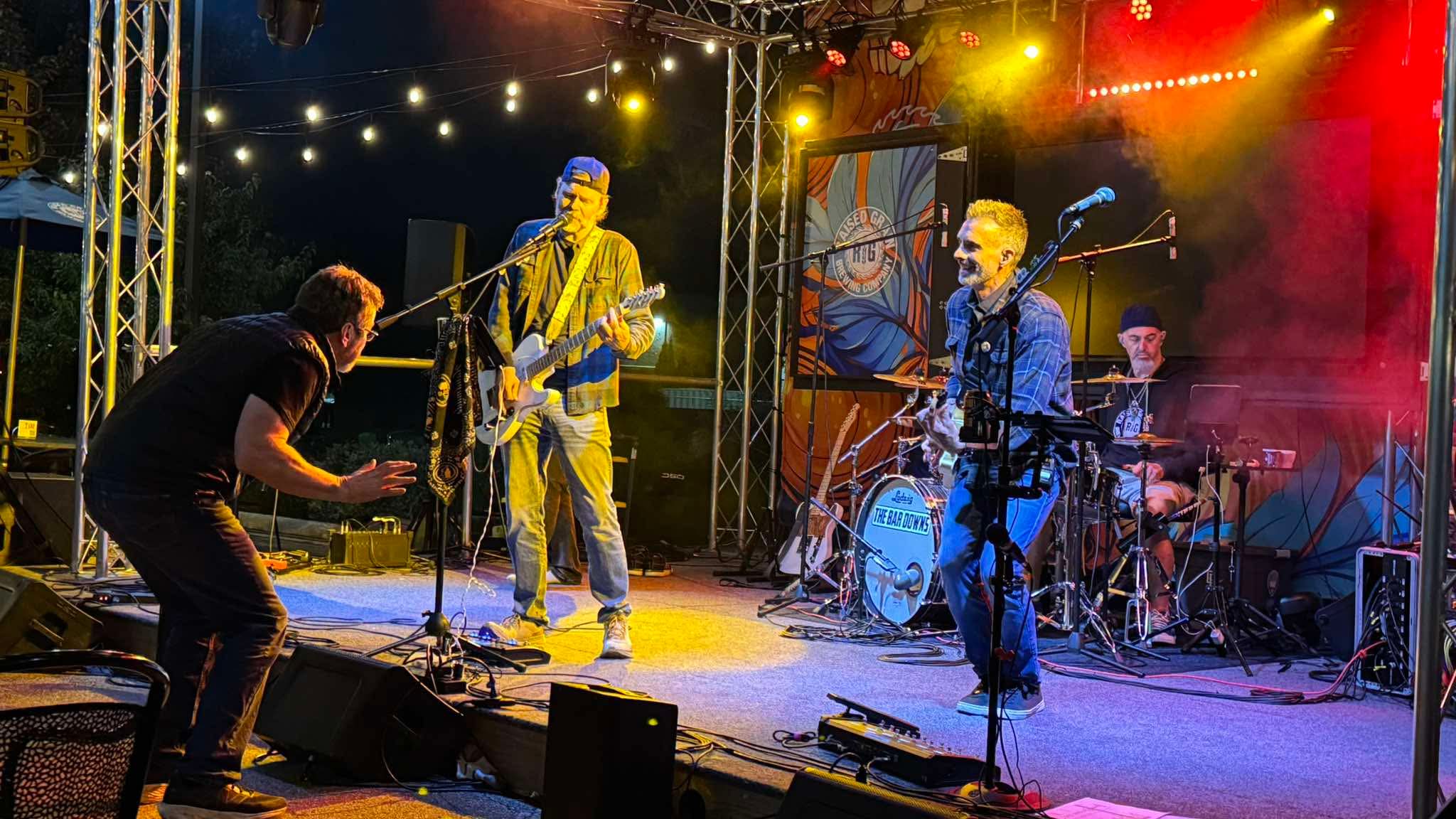 Live music under yellow and red outdoor stage lights