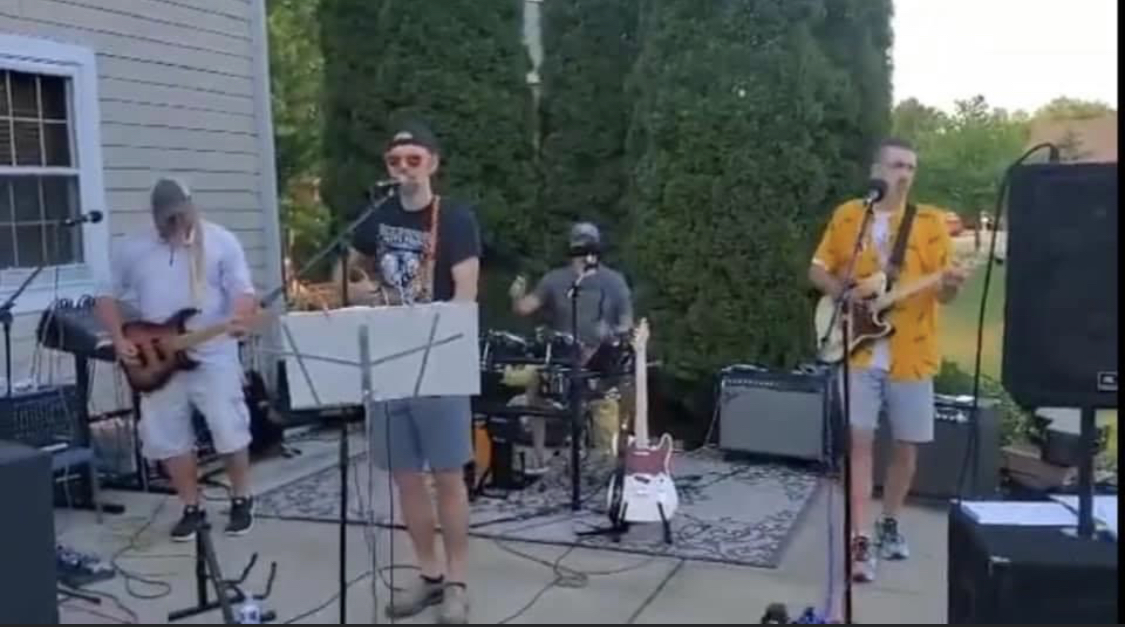 An early backyard performance beside a house